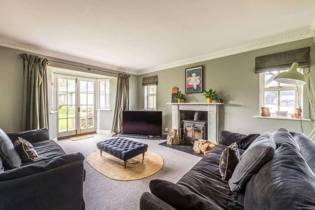 Also adjoining the entrance hall is a study with views over the garden which leads in turn to a snug, a cosy room with a wood burning stove and French doors to the terrace and garden