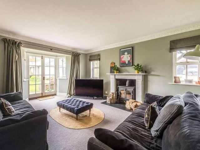 Also adjoining the entrance hall is a study with views over the garden which leads in turn to a snug, a cosy room with a wood burning stove and French doors to the terrace and garden