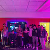Students from East Sussex College Esports course with Care for the Carers, Amy (fourth from left), Default Interactive’s Alex (second from left) and Young Adult Carer, Josh (far right). 