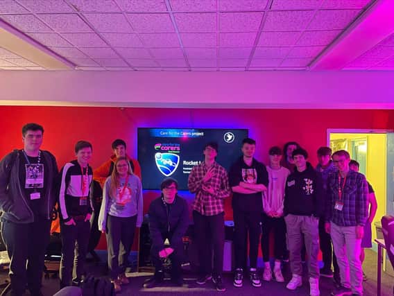 Students from East Sussex College Esports course with Care for the Carers, Amy (fourth from left), Default Interactive’s Alex (second from left) and Young Adult Carer, Josh (far right). 
