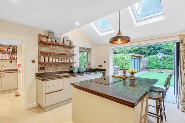 The open plan entertaining kitchen has bifold doors to the immaculate garden.