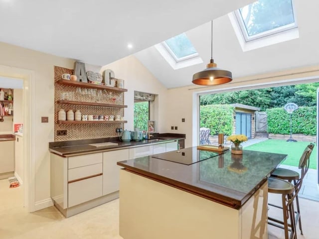 The open plan entertaining kitchen has bifold doors to the immaculate garden.