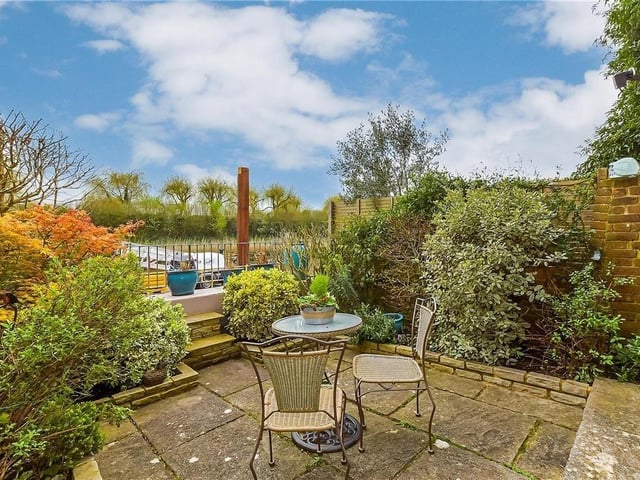 This modern town house with waterside garden is tucked away on a desirable private development in the heart of Arundel. It comes to the market with Cubitt & West, priced at £700,000.