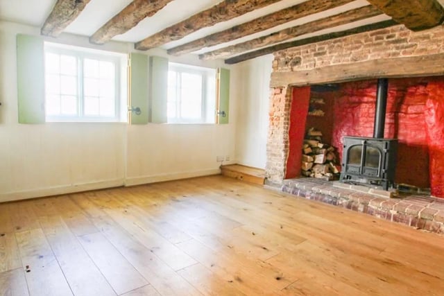The spacious living room has a large inglenook fireplace