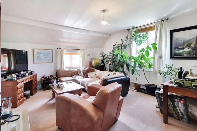 A three bedroom flat with a garage is situated at the far end of the outbuilding