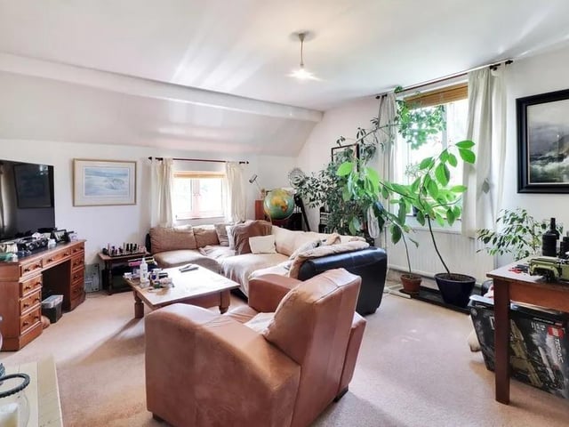 A three bedroom flat with a garage is situated at the far end of the outbuilding