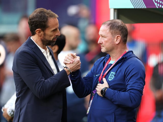 DOHA, QATAR - NOVEMBER 21: Gareth Southgate, Head Coach of England, embraces Steve Holland, Assistant Head Coach prior to the FIFA World Cup Qatar 2022 Group B match between England and IR Iran at Khalifa International Stadium on November 21, 2022 in Doha, Qatar. (Photo by Richard Heathcote/Getty Images)