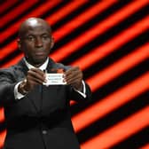 Cameroonian former football player Stephane Mbia shows the paper slip of Brighton & Hove Albion during the draw for the group stages of the 2023/24 UEFA Europa League at The Grimaldi Forum in the Principality of Monaco. Picture by NICOLAS TUCAT/AFP via Getty Images
