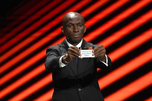 Cameroonian former football player Stephane Mbia shows the paper slip of Brighton & Hove Albion during the draw for the group stages of the 2023/24 UEFA Europa League at The Grimaldi Forum in the Principality of Monaco. Picture by NICOLAS TUCAT/AFP via Getty Images