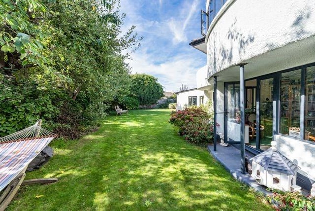 The property sits at an angle on a mature plot, measuring just under a quarter of an acre, with a predominately south westerly rear garden.