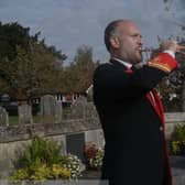 A member of the Petworth Town Band blows a bugle in remembrance. Image: Petworth Town Band