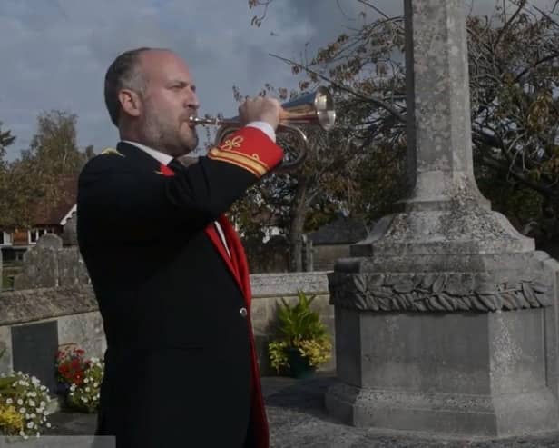 A member of the Petworth Town Band blows a bugle in remembrance. Image: Petworth Town Band