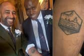 Mr Babarinde revealing his tattoo to Mr Lammy. Photo: Josh Babarinde
