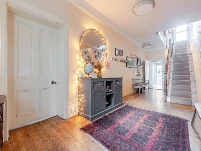 The porch door opens to a grand entrance hall
