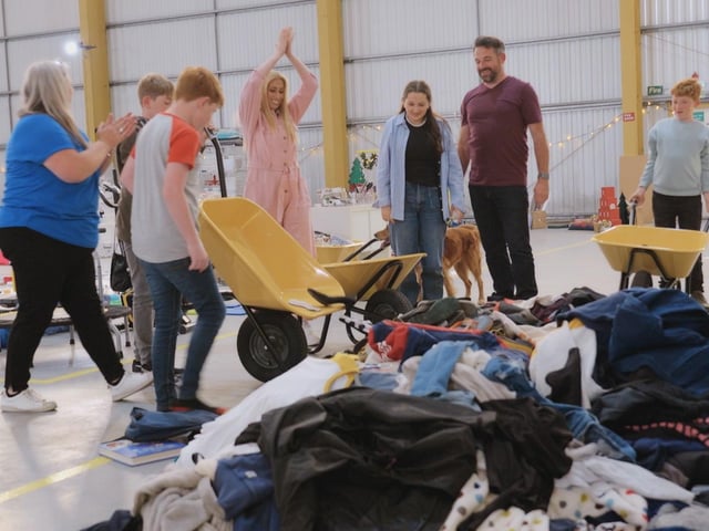 The Appleyards decluttering in the Sort Your Life Out warehouse, cheered on by Stacey Solomon