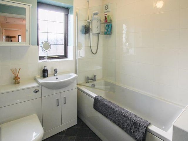 The family bathroom is on the first floor, and comprises bath with shower above, wash hand basin with vanity unit and low-flush WC.