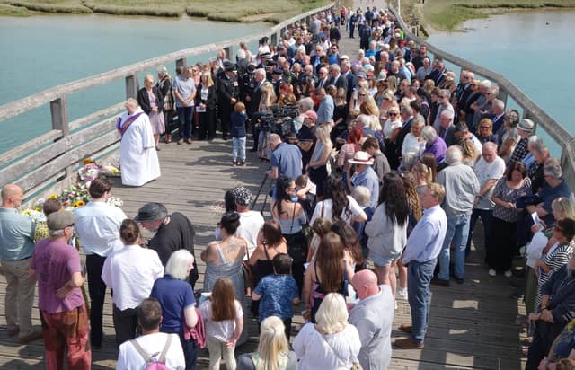 Deacon Julie Newson leads the service on Shoreham Old Tollbridge and the silence
