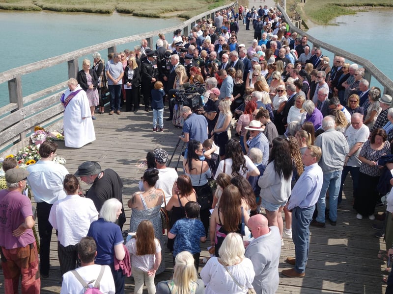 Deacon Julie Newson leads the service on Shoreham Old Tollbridge and the silence