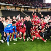 The Crawley Town players, manager Scott Lindsey and staff including Tom Allman (third from left) celebrate victory in front of their supporters during the EFL Sky Bet League 2 play-off second leg match between Milton Keynes Dons and Crawley Town at stadium:mk, Milton Keynes, England on 11 May 2024