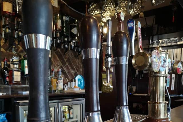 Beer pumps on the bar at The Bell Inn in Broyle Road
