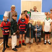 Highfield and Brookham pupils presented a cheque for £7,068 to Liphook Food Bank