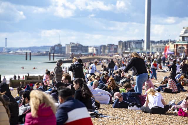 People enjoy the spring sunshine this Good Friday on Brighton beach in East Sussex.