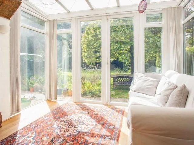 A light and airy garden room has French doors into the garden