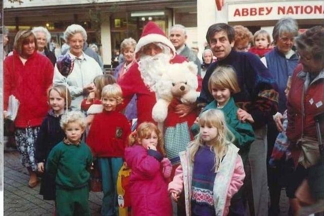 Children meet Father Christmas in the 1980s.