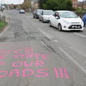 Graffiti seen in Chichester on Saturday, April 6, urging West Sussex County Council to fix several large potholes. Photo: Eddie Mitchell