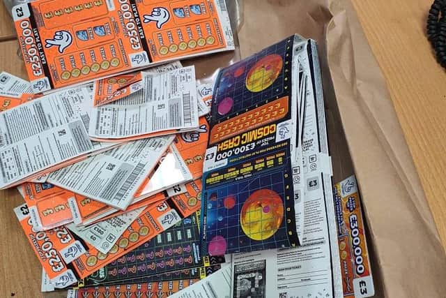 Police said that, once on the roof, officers found the suspect and a Tesco bag full of scratch cards – which were recovered. Photo: Sussex Police