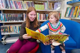 Helena Dollimore, labour's MP Candidate for Hastings and Rye reading to a little girl