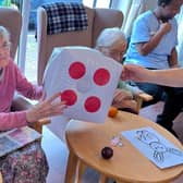 Residents at Mountside Care Home roll the dice of fun at their unforgettable Easter Bunny Drive