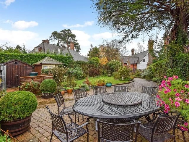 The garden has several paved seating and dining areas
