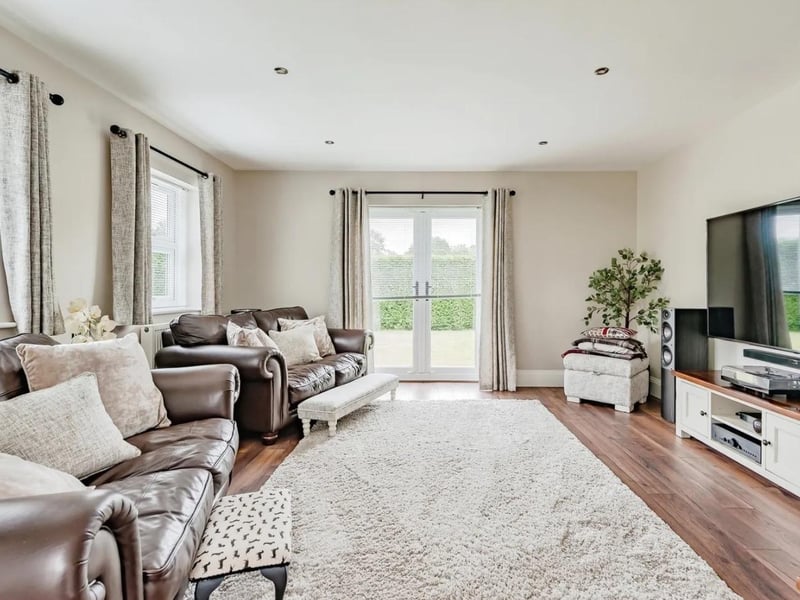 The family room has double glazed French doors to the garden and two double glazed windows to the side
