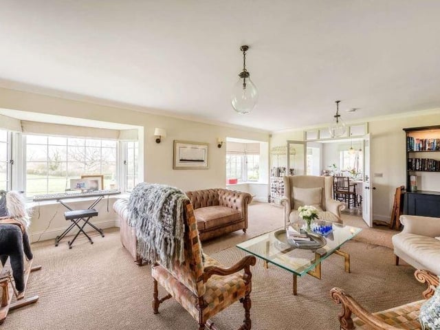From the dining room, glazed double doors open to the spacious drawing room, which offers views over the paddock to the north via two large bay windows