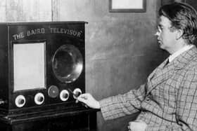 John Logie Baird views his televisor
