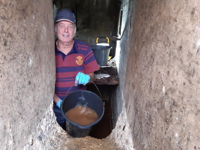 A bucket chain of volunteers from Ferring History Group and Ferring Conservation Group, including Worthing West MP Sir Peter Bottomley, form a bucket chain to bail out nine inches of water from the Ferring pillbox