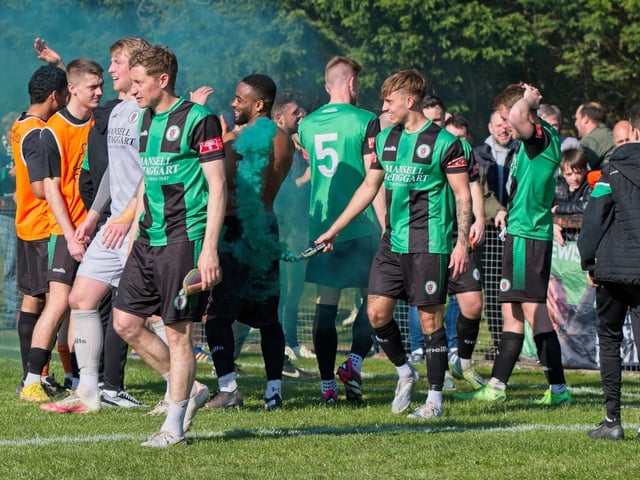 Burgess Hill Town players, fans and staff celebrate surviving in the Isthmian south east division at the end of their 0-0 draw with Beckenham