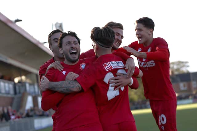 Worthing's players celebrate one of the two Danny Cashman goals that earned the Reds an FA Cup first round place | Picture: Mike Gunn