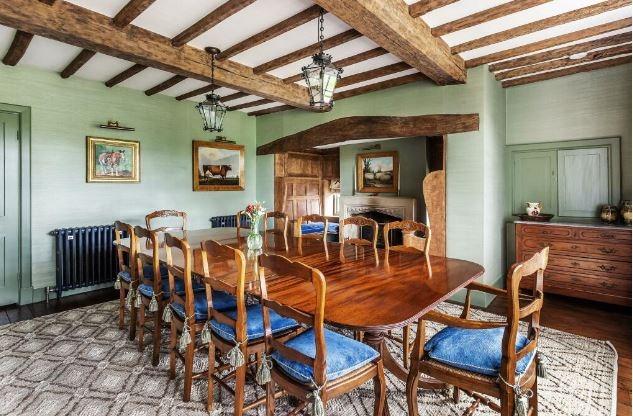 The formal dining room features a beamed ceiling