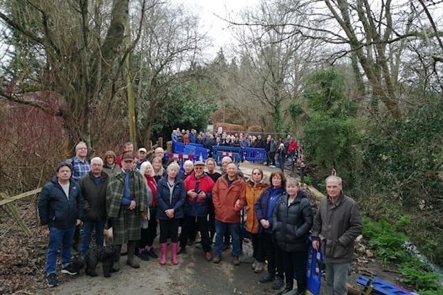 A protest has been held in a South Downs village amid the prolonged closure of a key road.