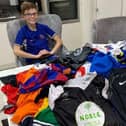Teddy with the football shirts he collected
