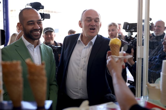 EASTBOURNE, ENGLAND - MAY 24: Liberal Democrat leader Ed Davey with Liberal Democrat candidate Josh Babarinde get an ice cream during a visit to the marginal seat of Eastbourne on May 24, 2024 in Eastbourne, England. The Liberal Democrats are targeting Conservative marginal seats along the South Coast in the upcoming general election on July 4th.  (Photo by Dan Kitwood/Getty Images)