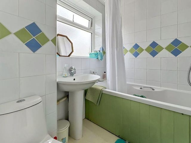 The family bathroom has a modern white suite and tiled walls