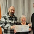 Left to Right: Brighton comedian Dave Fensome, Parkinson's Support Group representative, Judy Byrne, and Paul Margo of 3Degree Catering at the EBM Centre, Peacehaven.