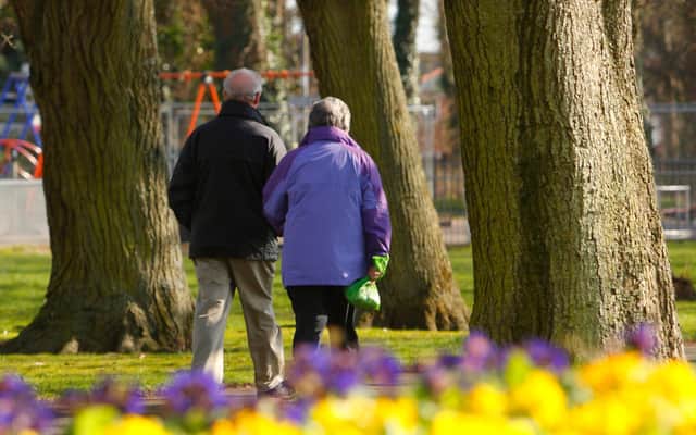 File photo dated 14/03/13 of a couple walking through a park as almost one in four people expect to work to the age of 70 or over and more than half admit they need to save more for retirement, according to a new report.