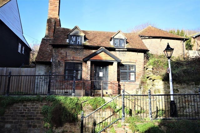 The detached property is in the High Street, opposite the Stables Theatre