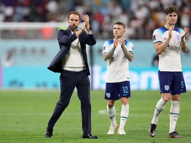 DOHA, QATAR - NOVEMBER 21: Gareth Southgate, Head Coach of England, applauds fans with Kieran Trippier and John Stones after the 6-2 win during the FIFA World Cup Qatar 2022 Group B match between England and IR Iran at Khalifa International Stadium on November 21, 2022 in Doha, Qatar. (Photo by Richard Heathcote/Getty Images)