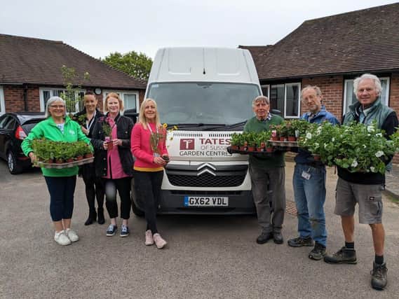 Donated plants arrive at the hospice: Wendy Agate, Becky Stevens, Victoria Webber and three volunteer gardeners from St Peter & St James Hospice meet Selena Peace from Tates of Sussex Garden Centres for the handover.