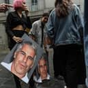 A protest group called "Hot Mess" hold up signs of Jeffrey Epstein in front of the Federal courthouse in New York. Picture: Stephanie Keith/Getty Images